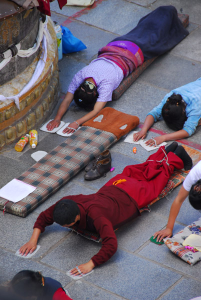 Tibetan pilgrims prostrating in the forecourt