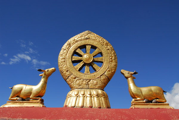 Two golden deer facing a Dharma wheel 