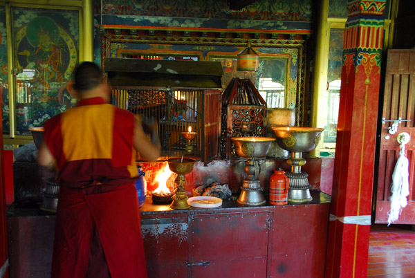 Monk adding yak butter to lamps, Palha Lu-puk
