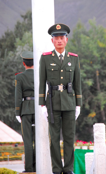 Guards at the base of the pole with the Chinese flag, Potola Square