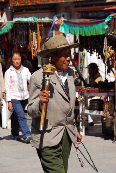 Tibetan man spinning a prayer wheel