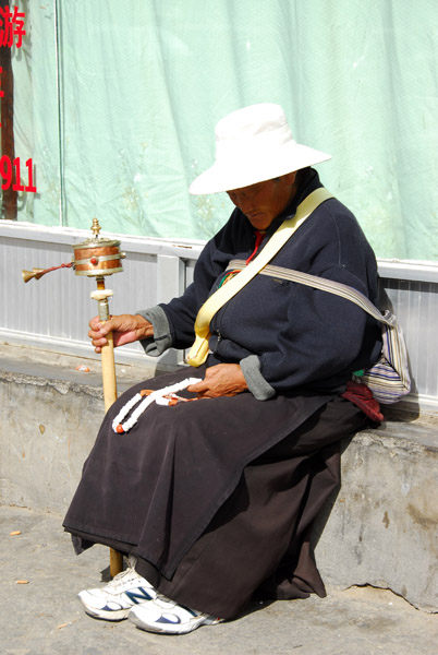 Woman spinning a prayer wheel