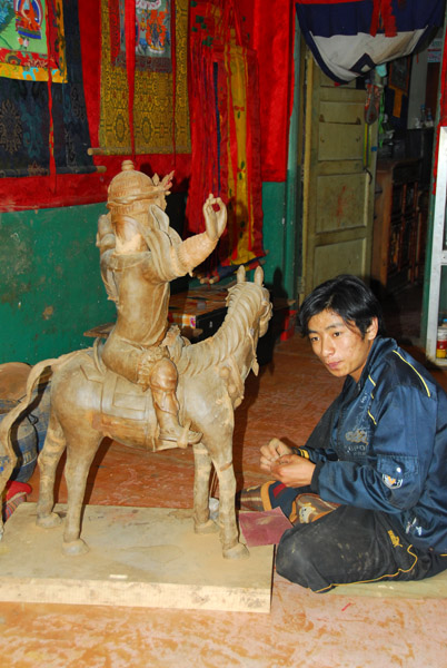 Craftsman working on a mounted sculpture