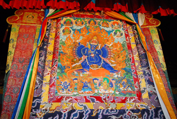Large thangka hanging in the center of the nunnery's main assemby hall