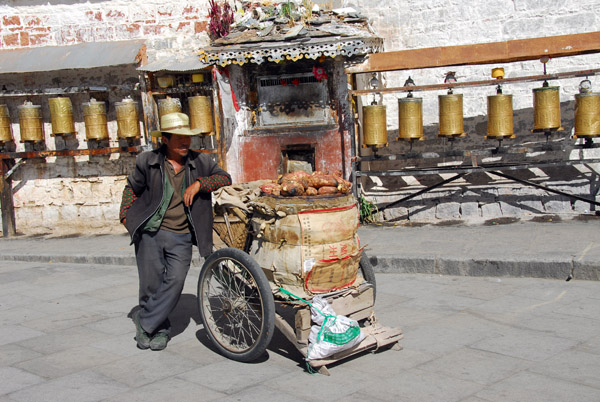 Bicycle rickshaw in front of prayer wheels of the Potola kora circuit