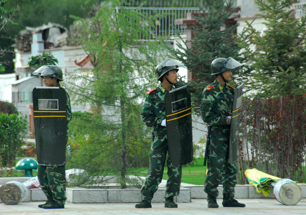 Chinese soldiers in riot gear on a street corner in a new part of Lhasa