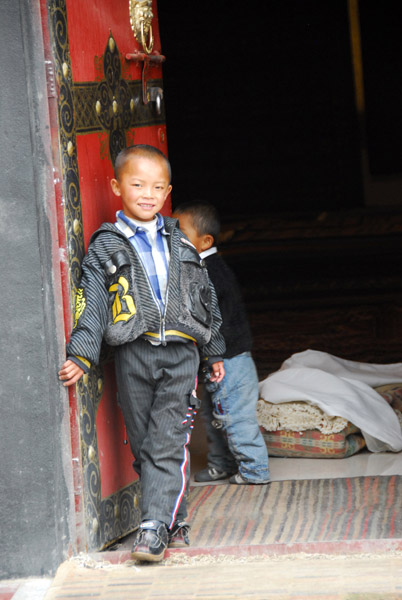 Boys at the carpet showroom near Nechung Monastery