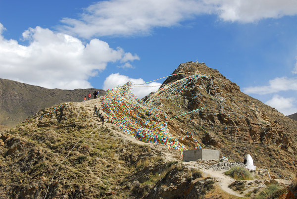 The rocky peaks behind Yumbulagang covered with prayer flags