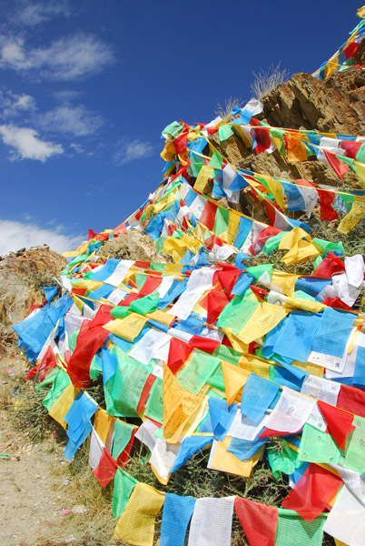 Each piece of colored cloth is printed with a Tibetan prayer