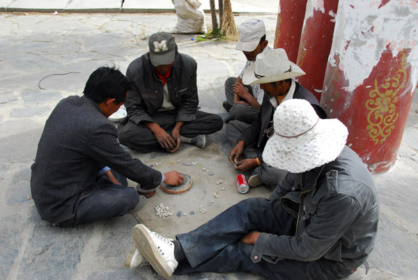 Men passing time playing a game