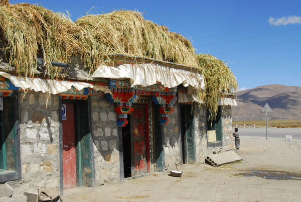 Tibetan houses with feed for the livestock stored on the roof