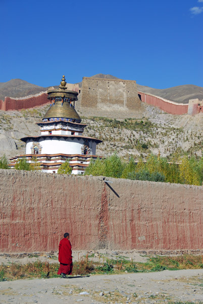 Monk walking along the walls of Pelkor Chde Monastery