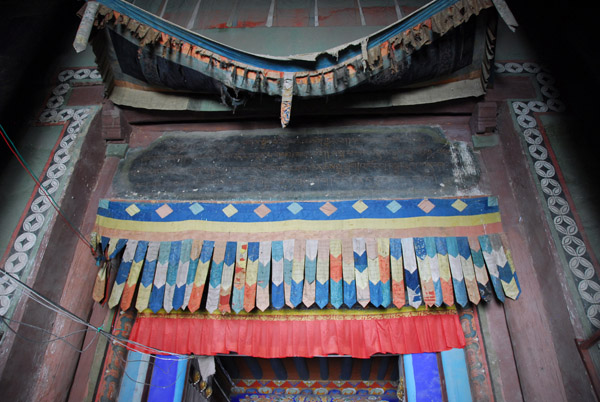 Faded banners over the passage to the inner courtyard, Sakya Monastery