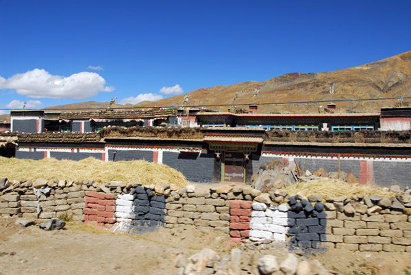 The Sakyapa color scheme painted on a mud brick wall