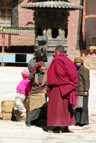 Monk talking with Tibetan women, Sakya