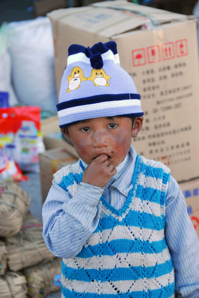 Tibetan boy with a cute hat but dirty face