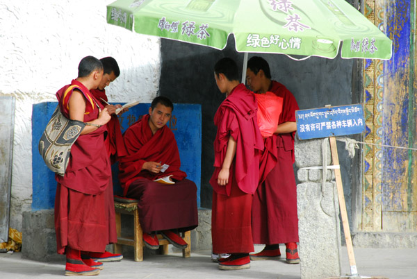 Monks gathered around the gate to Tashilhunpo Monastery