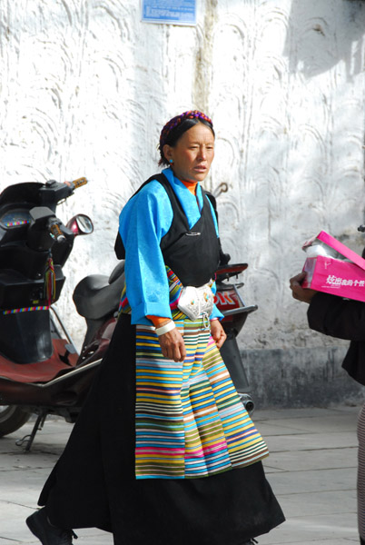 Tibetan woman in traditional clothing with a colorful apron