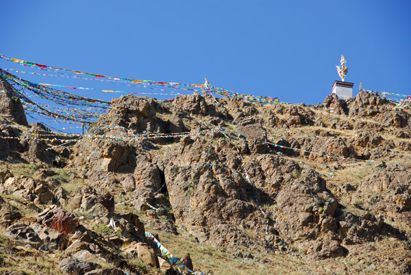 Prayer flag covered mountain behind Tashilhunpo Monastery