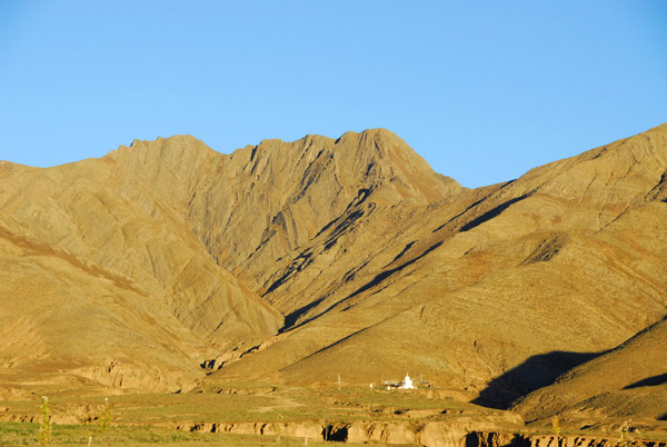 Early morning light on the hills with a lone white stupa