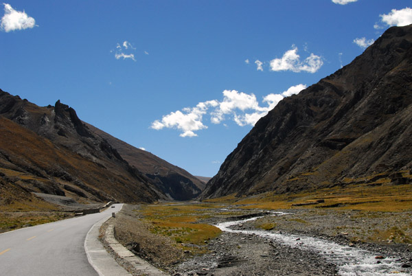 The Friendship Highway passing through a narrow river valley southwest of Lhatse