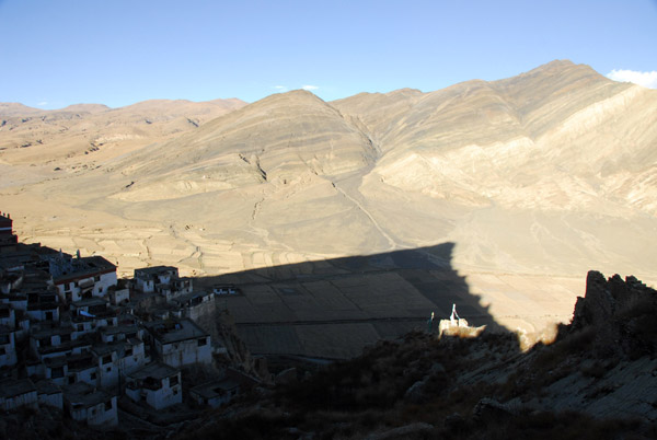 Shadow of the mountain of Shegar Dzong cast across the valley floor
