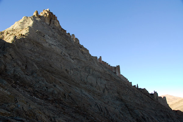 The walls of Shegar Dzong following the steep slope of the mountain
