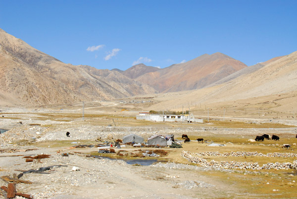 Quarry in the Tibetan farmer plowing a field along the Matsang Tsangpo river