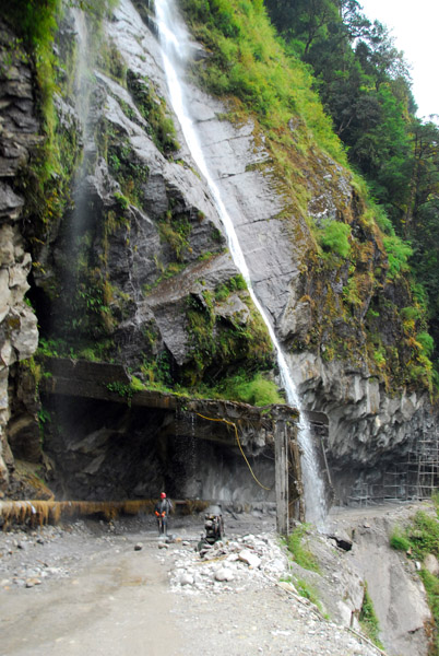 The Friendship Highway passing under a waterfall
