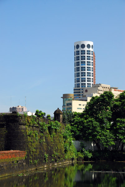 Round tower on the north side of the Pasig River rising behind Fort Santiago