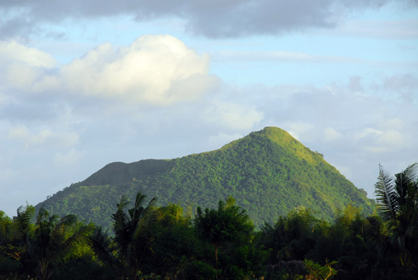 Summit of Binitiang Malaki seen from the west over the trees