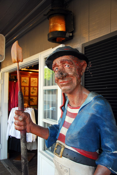 Wooden statue in front of a tourist shop