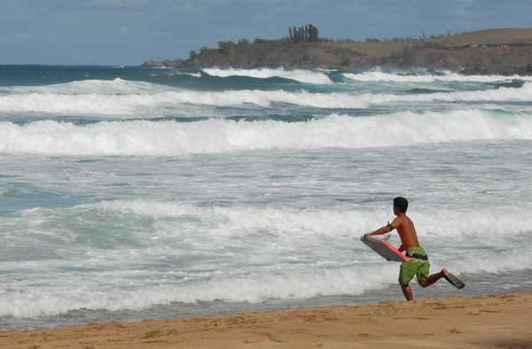 Boogie-boarder running for the surf, Fleming Beach