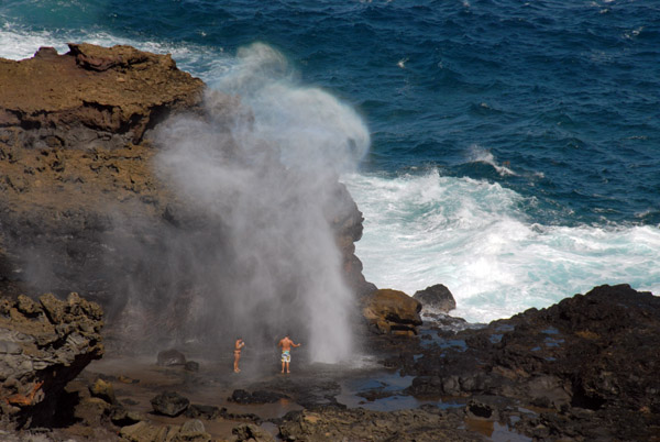 Tourists getting sprayed by Nakalele Blowhole, Maui