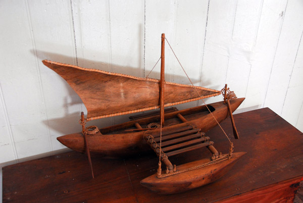 Carved wooden outrigger boat