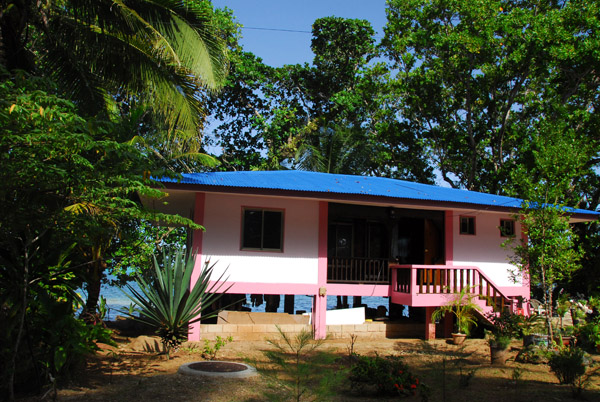 Little pink house on stilts along the waterfront of Melekeok