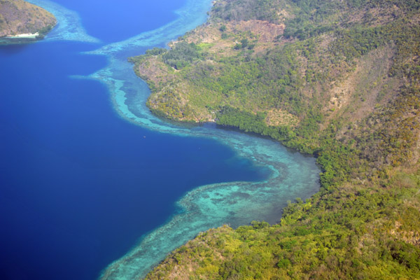 Shallow blue water and coral reefs on the sheltered south side of Cabilauan Island, Philippines