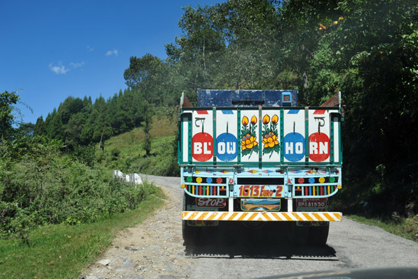 A truck on the road to Thimphu painted up like those in India