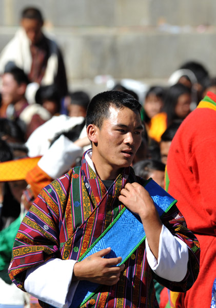 Bhutanese man wearing a special blue sash called a kabney