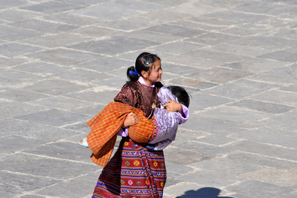 Mother carrying away a little girl