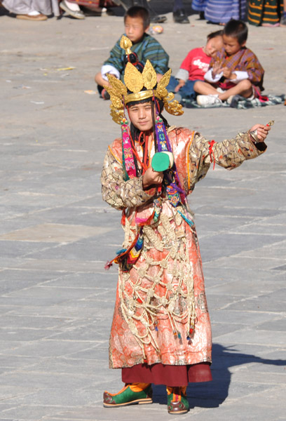 Bhutanese dancer with an ornate gilded crown and pointy shoes