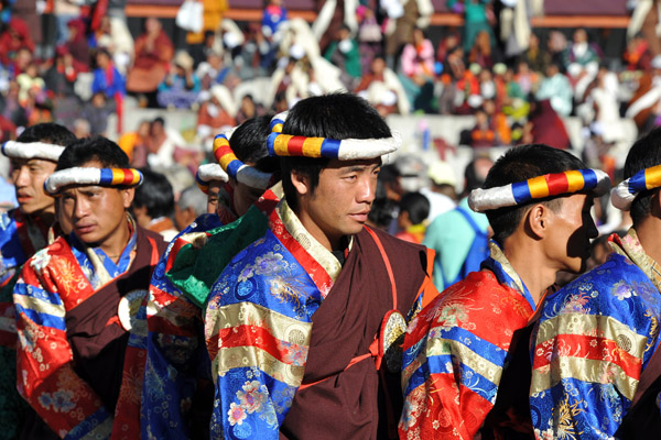 Men wearing head rings with the colors of the Buddhist flag