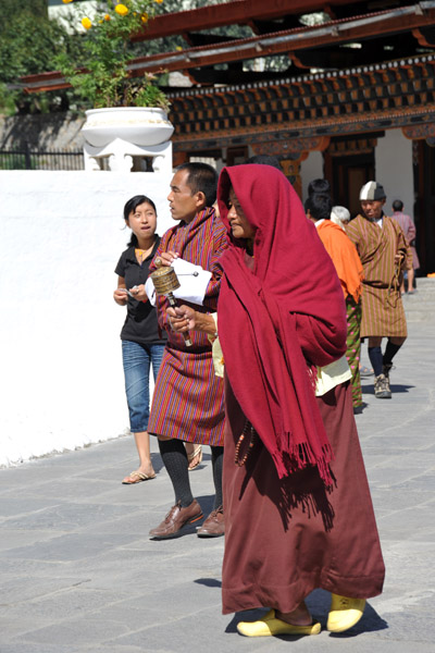 Bhutanese monk with a prayer wheel