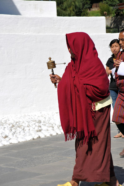 Bhutanese monk with a prayer wheel