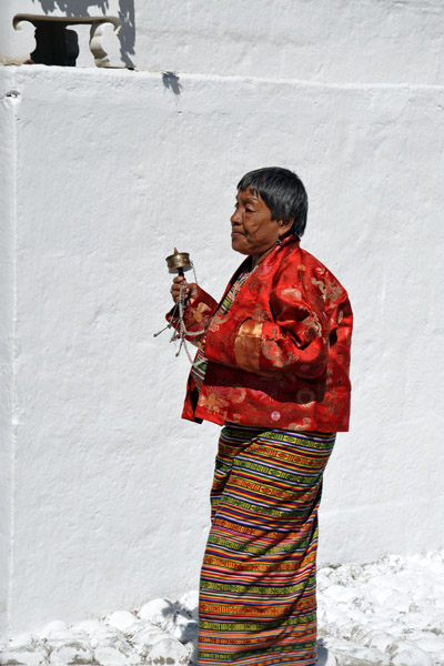 Bhutanese woman with a prayer wheel