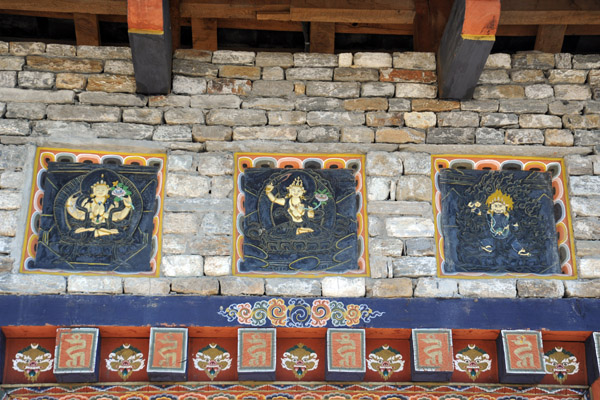 Three stone carvings on the wall to the National Memorial Choeten, Thimphu