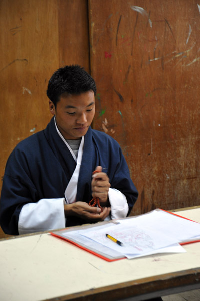 Student taking a break with his beads