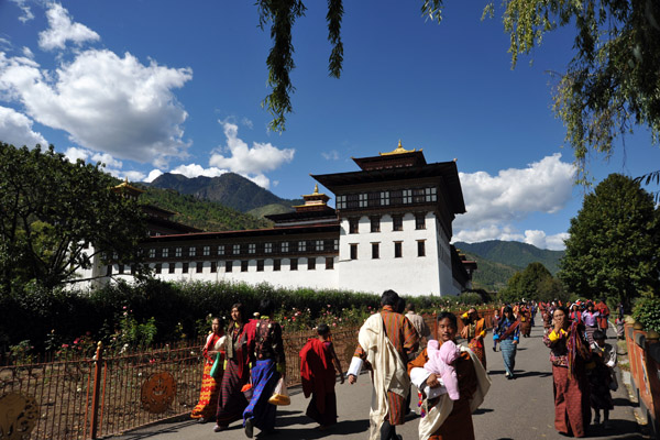Bhutanese dressed in their traditional clothes walking to and from Thimphu Dzong