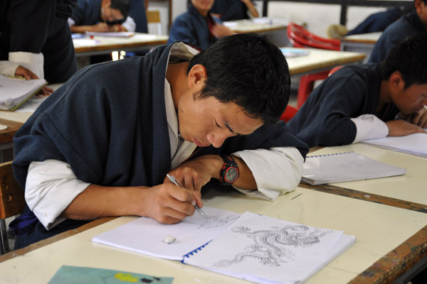 Concentrating on drawing Bhutan's national dragon