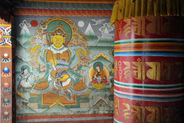 Prayer Wheel and a painting of Namthosey, the gold king of the north, who holds a mongoose and victory banner